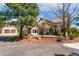 Stunning house with circular driveway, meticulous landscaping, and mature trees surrounding the beautiful property at 2880 Lake Meadow Dr, Monument, CO 80132
