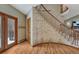 Inviting foyer with hardwood floors and decorative wall art leading to the staircase at 2880 Lake Meadow Dr, Monument, CO 80132
