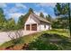 Detached two-car garage with matching roof tiles and plenty of surrounding greenery at 2880 Lake Meadow Dr, Monument, CO 80132