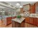 Gourmet kitchen featuring granite counters, custom cabinetry, and center island at 2880 Lake Meadow Dr, Monument, CO 80132