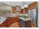 Charming kitchen boasts custom wood cabinets, granite countertops, and stainless steel appliances at 2880 Lake Meadow Dr, Monument, CO 80132