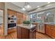Open kitchen featuring a granite island, hardwood floors, and stainless steel appliances at 2880 Lake Meadow Dr, Monument, CO 80132