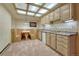 Basement kitchenette with custom cabinets, dining booth, and a tiled ceiling at 2880 Lake Meadow Dr, Monument, CO 80132