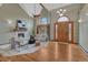 Spacious living room boasting a fireplace, cathedral ceiling, and large arched window at 2880 Lake Meadow Dr, Monument, CO 80132