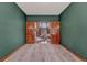 Through wooden double doors an inviting room reveals a fireplace and bright views from the windows at 2880 Lake Meadow Dr, Monument, CO 80132