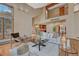 Open concept living room with vaulted ceiling, wood floors, and large windows showcasing natural light at 2880 Lake Meadow Dr, Monument, CO 80132