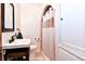 Cozy bathroom featuring a pedestal sink, arched shower, and convenient storage space at 1765 S Franklin St, Denver, CO 80210