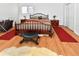 Comfortable bedroom featuring a wooden bed frame, matching end tables, and decorative rugs at 1765 S Franklin St, Denver, CO 80210