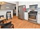 Well-equipped kitchen with stainless steel appliances, white cabinetry, backsplash, and a breakfast bar at 1765 S Franklin St, Denver, CO 80210