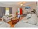 Spacious living room with hardwood floors, comfortable sofas, a flat-screen TV, and bright red door at 1765 S Franklin St, Denver, CO 80210
