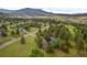 Expansive aerial view of the property, displaying its wooded surroundings and neighborhood views at 29663 Paint Brush Dr, Evergreen, CO 80439