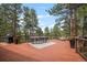 Spacious back deck with outdoor dining area and views of the surrounding trees at 29663 Paint Brush Dr, Evergreen, CO 80439