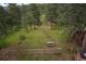 Backyard featuring a seating area, fire pit and wooded scenery at 29663 Paint Brush Dr, Evergreen, CO 80439