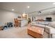 Finished basement space with kitchenette, bar seating, and comfortable lounge area at 29663 Paint Brush Dr, Evergreen, CO 80439