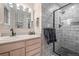 Modern bathroom featuring tiled walk-in shower with glass door, floating vanity, and modern fixtures at 29663 Paint Brush Dr, Evergreen, CO 80439