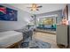 Bright bedroom with a window seat, built-in shelving, and light wood flooring at 29663 Paint Brush Dr, Evergreen, CO 80439