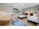 Comfortable bedroom featuring two twin beds, statement wallpaper, cozy decor, and bright natural light at 29663 Paint Brush Dr, Evergreen, CO 80439