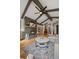 Inviting living room featuring vaulted ceilings, exposed beams, a stone fireplace and open floor plan at 29663 Paint Brush Dr, Evergreen, CO 80439