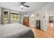 Bright and airy main bedroom with hardwood floors, nice window views, and open access to other areas at 29663 Paint Brush Dr, Evergreen, CO 80439