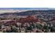 Aerial view of homes nestled near red rocks and trees at 6931 Buckskin Dr, Littleton, CO 80125