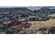 Aerial view of homes and a golf course near red rocks at 6931 Buckskin Dr, Littleton, CO 80125