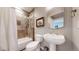 Basement bathroom with tile shower and pedestal sink at 6931 Buckskin Dr, Littleton, CO 80125