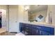 Double vanity bathroom with dark cabinetry and walk-in closet at 6931 Buckskin Dr, Littleton, CO 80125