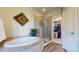 Bathroom with soaking tub, walk-in shower, and separate closet at 6931 Buckskin Dr, Littleton, CO 80125