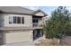 Townhome exterior featuring a balcony and attached garage at 6931 Buckskin Dr, Littleton, CO 80125