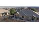 Tan townhome with patio and mountain views in the background at 6931 Buckskin Dr, Littleton, CO 80125