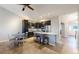 Modern kitchen with dark cabinetry, island, and stainless steel appliances at 6931 Buckskin Dr, Littleton, CO 80125