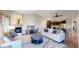Comfortable living room with fireplace and views into the connected kitchen at 6931 Buckskin Dr, Littleton, CO 80125