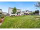 Expansive backyard featuring lush green grass, garden beds, and a charming wooden fence at 9579 Bighorn Way, Littleton, CO 80125