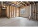 Unfinished basement with exposed beams and a window for some natural light at 9579 Bighorn Way, Littleton, CO 80125