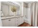Bathroom showcasing a double sink vanity with granite countertops and modern fixtures at 9579 Bighorn Way, Littleton, CO 80125