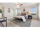 Well-lit main bedroom with neutral walls, carpet, ceiling fan, and walk-in closet at 9579 Bighorn Way, Littleton, CO 80125