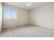 Bright bedroom features a ceiling fan and a window letting in natural light at 9579 Bighorn Way, Littleton, CO 80125
