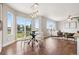 Bright dining area with a modern chandelier, seamlessly connected to the living room and kitchen at 9579 Bighorn Way, Littleton, CO 80125