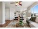Open-concept living room features hardwood floors and seamlessly connects to the dining area and kitchen at 9579 Bighorn Way, Littleton, CO 80125