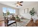 Stylish living room with a large window, a comfortable white sofa and hardwood floors at 9579 Bighorn Way, Littleton, CO 80125