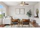 Tastefully decorated living room with hardwood floors, neutral tones, and a cozy seating arrangement at 9579 Bighorn Way, Littleton, CO 80125