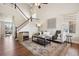 Bright living room with high ceilings, hardwood floors, a staircase, and contemporary decor at 9579 Bighorn Way, Littleton, CO 80125