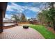 An inviting backyard with a brick patio, wooden deck, and lush lawn at 3150 S Pitkin St, Aurora, CO 80013