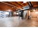 A spacious unfinished basement with concrete floor and visible ceiling beams at 3150 S Pitkin St, Aurora, CO 80013