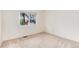 A cozy bedroom featuring neutral-toned walls and carpet, with a well-lit window at 3150 S Pitkin St, Aurora, CO 80013