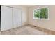 Bright bedroom with neutral carpet, window, and closet at 3150 S Pitkin St, Aurora, CO 80013