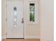 A beautiful front door with decorative glass and a sidelight window; the door is an inviting white at 3150 S Pitkin St, Aurora, CO 80013