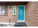 Close-up of the beautiful teal front door with decorative glass and a sidelight window on a brick home exterior at 3150 S Pitkin St, Aurora, CO 80013