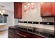 Modern kitchen featuring updated appliances, granite counters, and pendant lights at 3150 S Pitkin St, Aurora, CO 80013