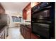 Bright kitchen featuring stainless steel appliances, dark countertops, and double oven at 3150 S Pitkin St, Aurora, CO 80013